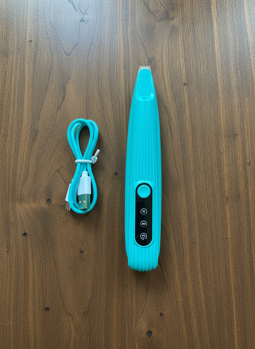 dog hair trimmer and a charging cable on a wooden surface