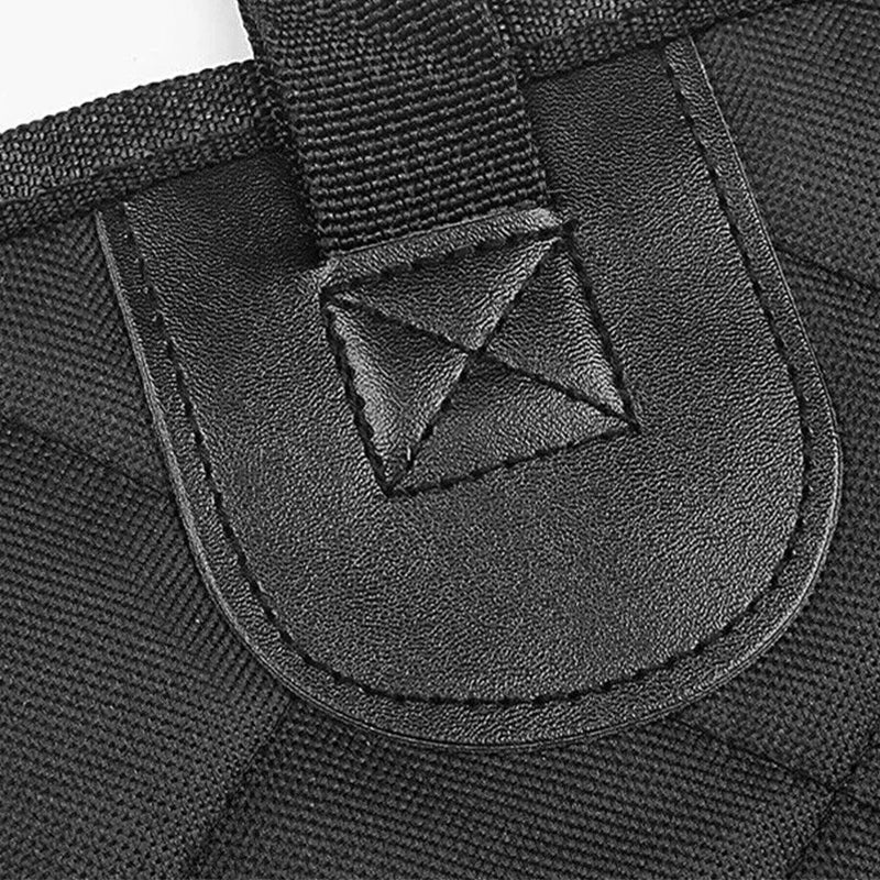 Close-up of a black strap with a triangular buckle on a textured black background